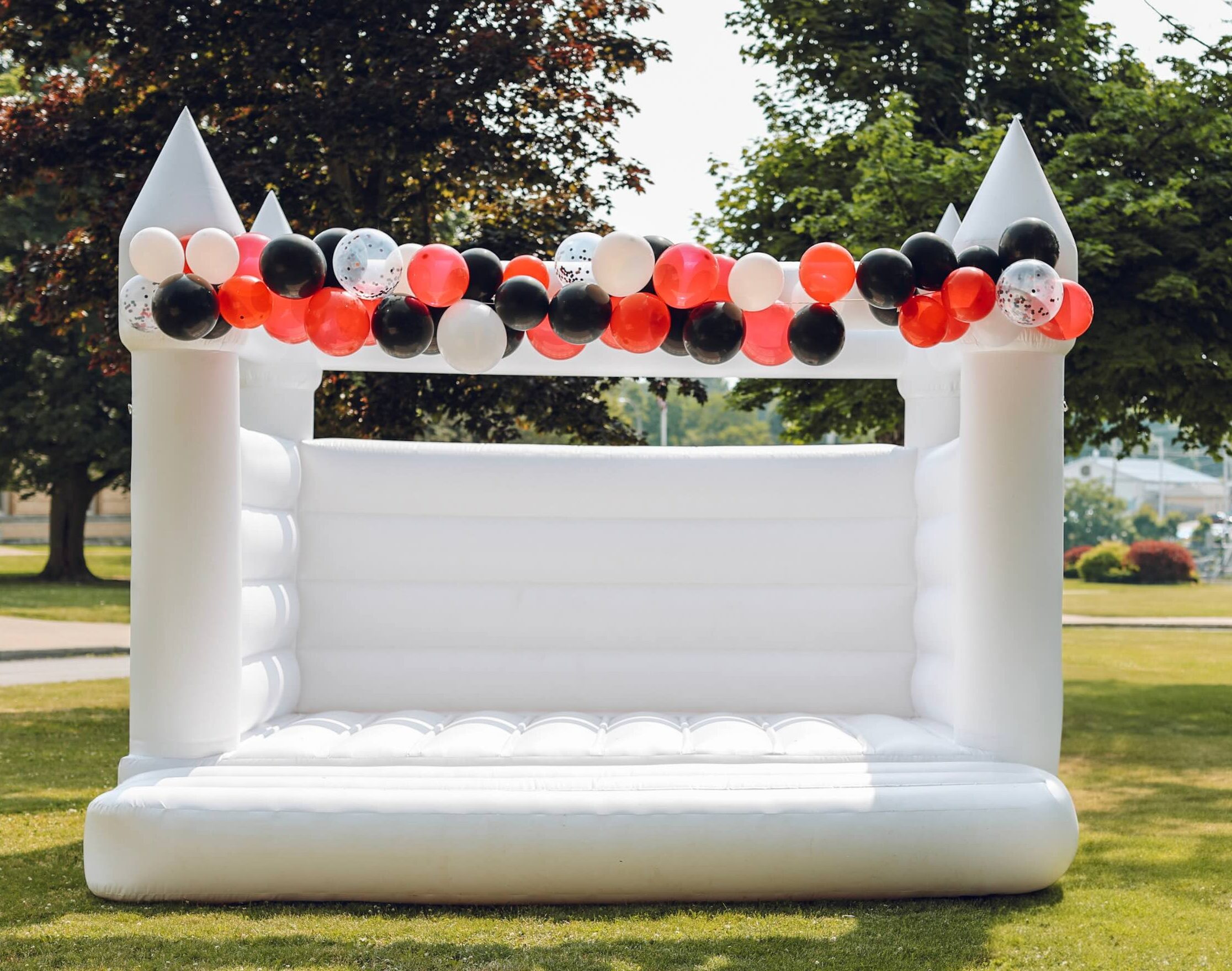 Sawyer 14x14 all white bounce house set up in a backyard
